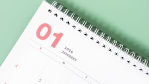 Close-up of a desk calendar opened to January 2026, showing January 1 at the top of the page